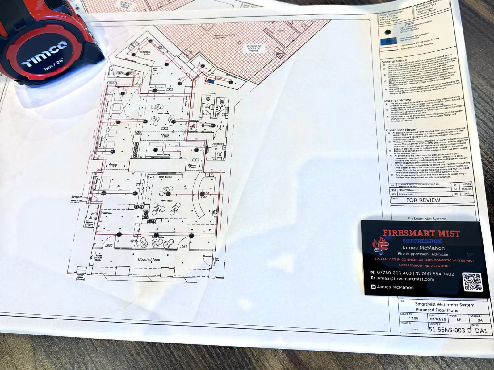 Firesmart Mist proposed floor plan drawings marked for review, with a James McMahon business card