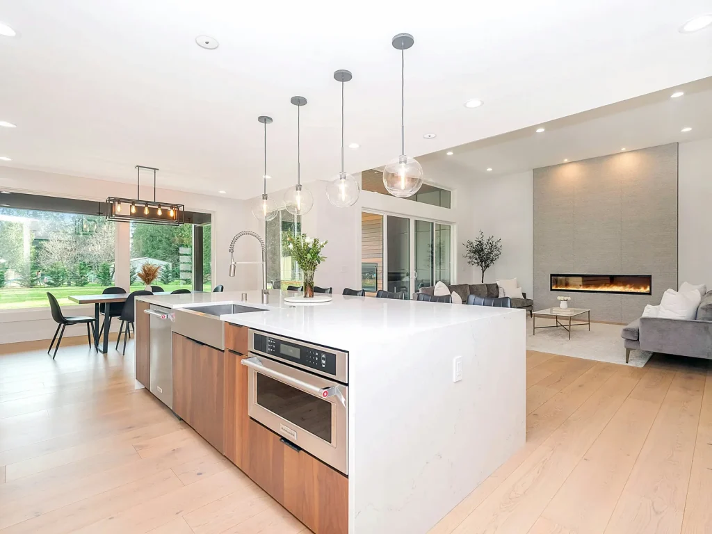 Open-plan kitchen with an island, pendant lights and living area