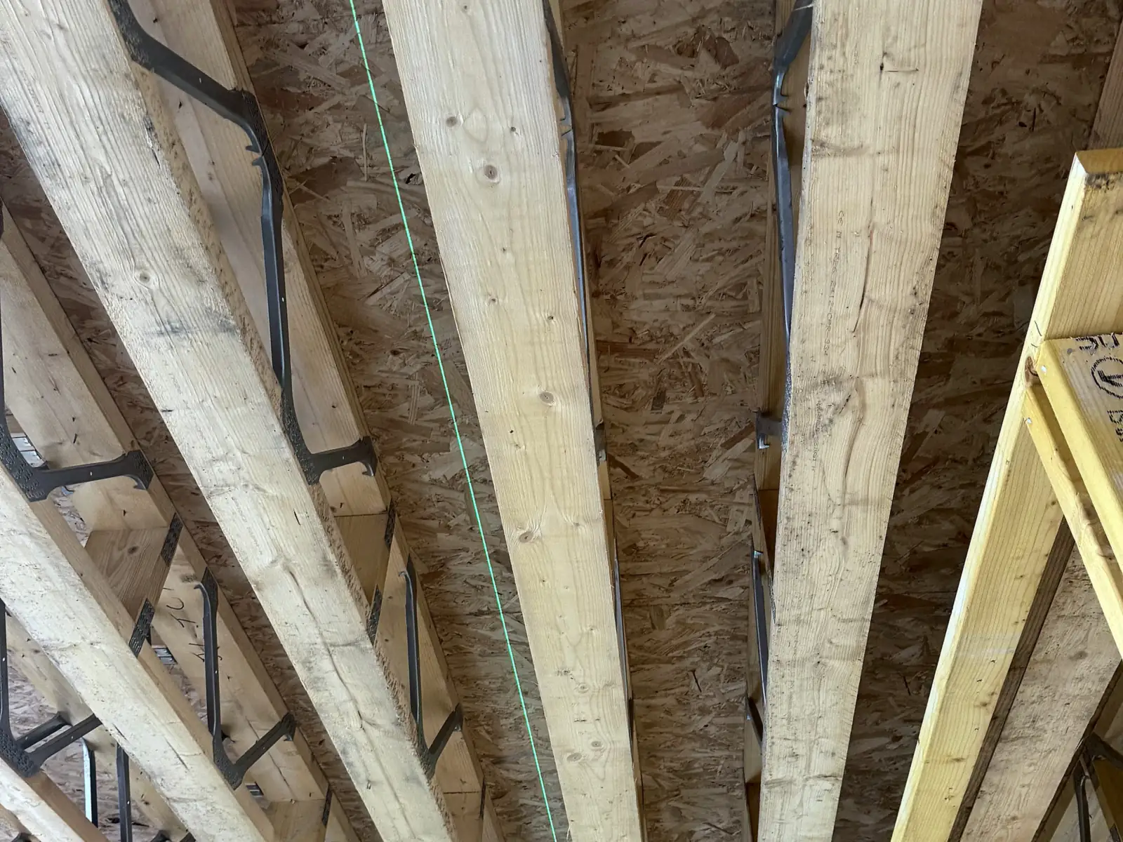 Timber joists and boarding in a new build, with pipework in the floor void