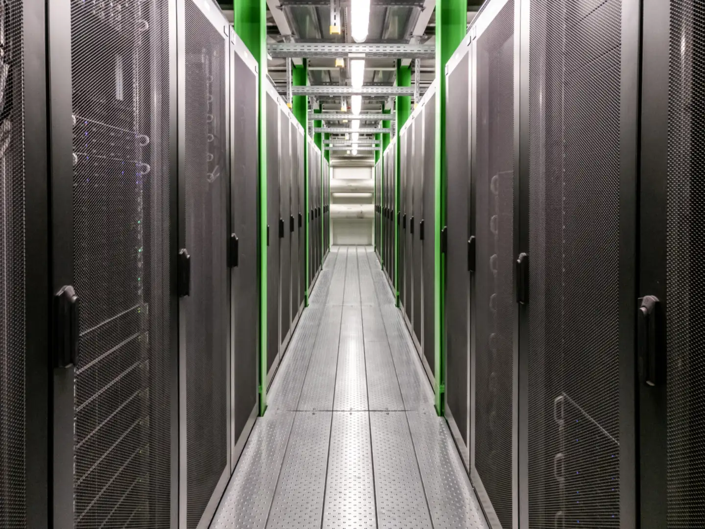 Data centre aisle between rows of enclosed server racks